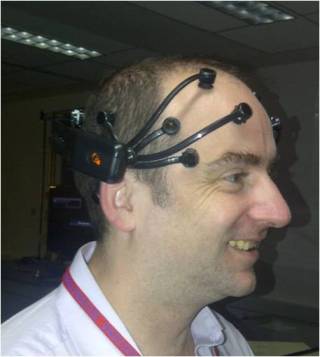 (Photo of me wearing the Emotiv headset, which measures the magnetic waves created by brain activity.)