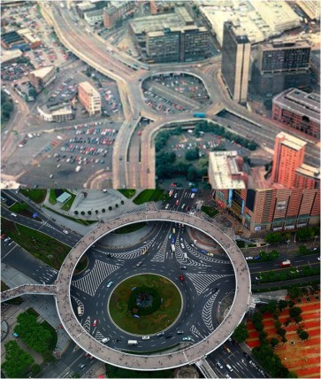 (Top: Birmingham's Masshouse Circus roundabout, part of the inner-city ringroad that famously impeded the city's growth. Bottom: This pedestrian roundabout in Lujiazui, China, constructed over a busy road junction, is a large-scale city infrastructure that balances the need to support traffic flows through the city with the importance that Jane Jacobs first described of allowing people to walk freely about the areas where they live and work. Photo by ChrisUK)